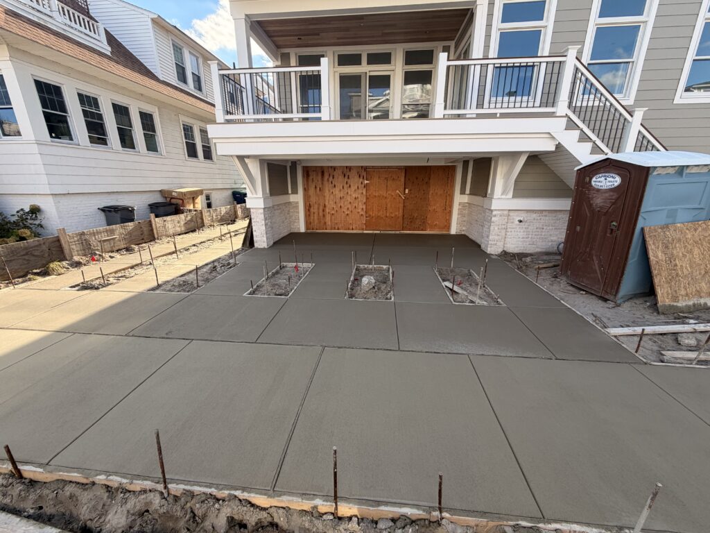 New concrete driveway installation with broom finish and control joints in Margate City, NJ